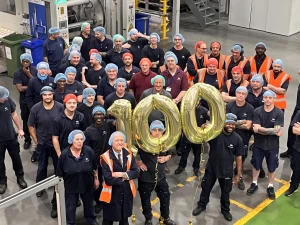 staff holding 100 ballon